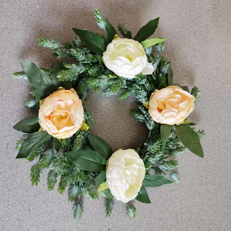 Lebensechter Blumenkranz mit grünen Akzenten
