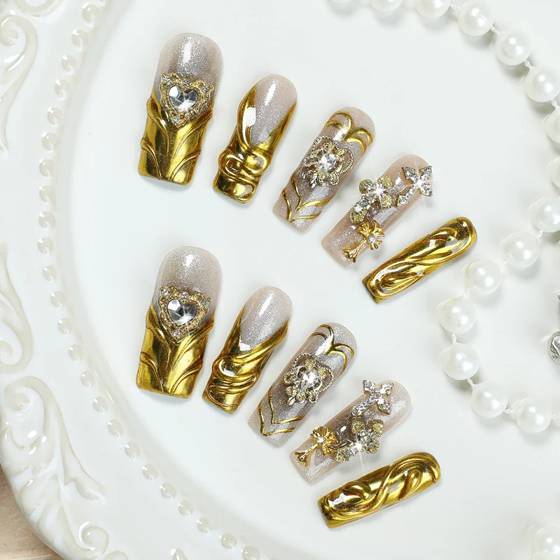 Kunstnagelset mit luxuriösen Goldverzierungen Karnz