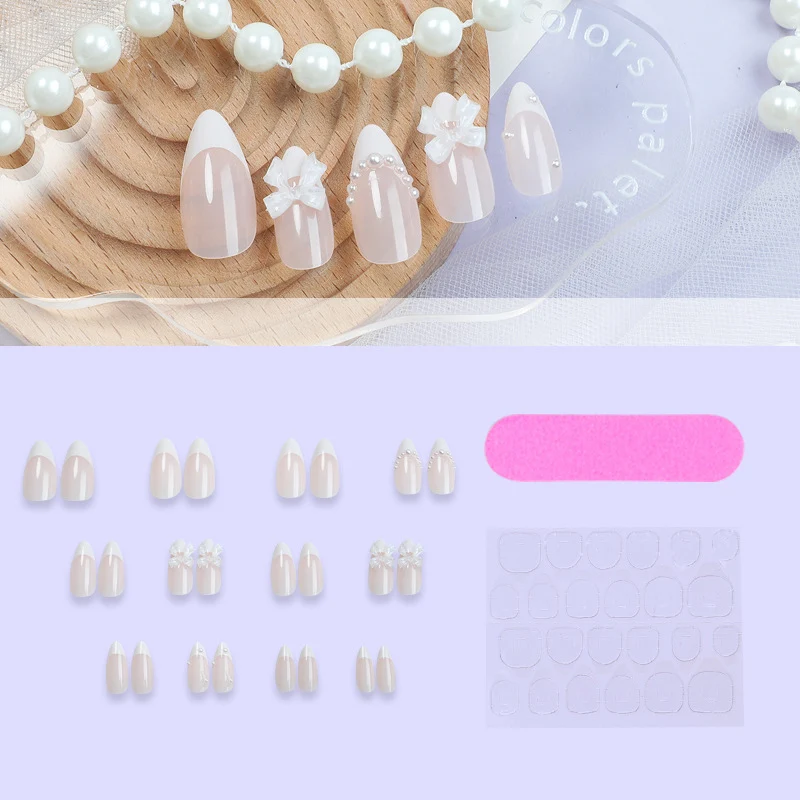Kunstnagelset mit eleganten Schleifen und Perlverzierungen Karnz