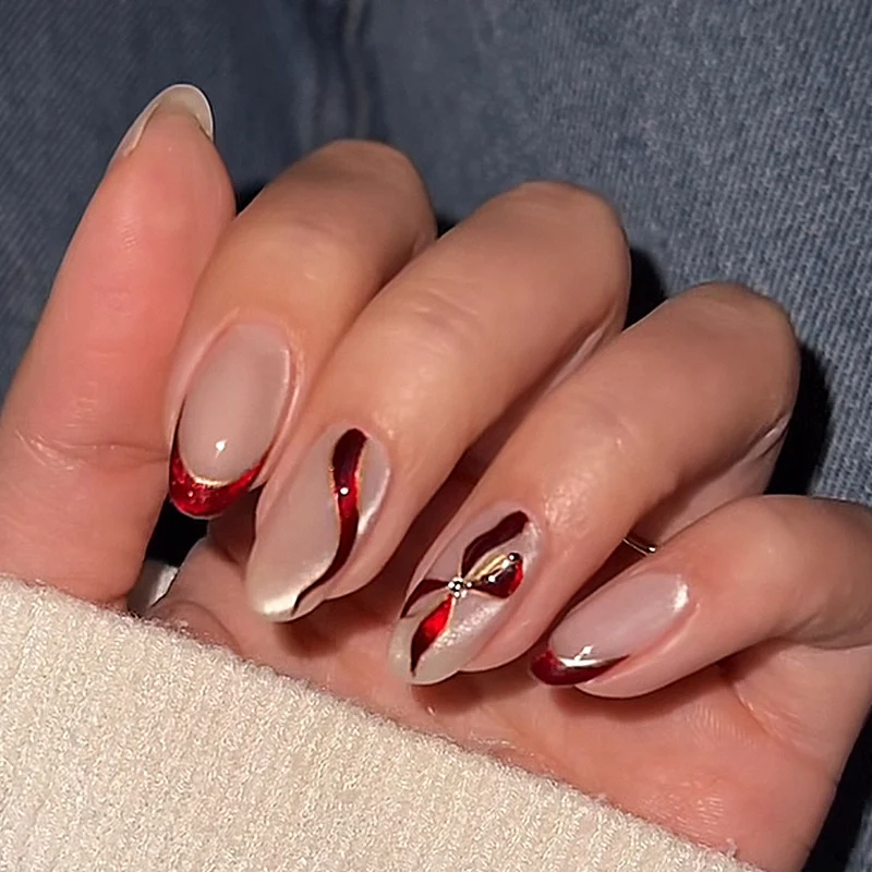Kunstnagelset mit eleganten Schleifen- und Glitzerakzenten Karnz