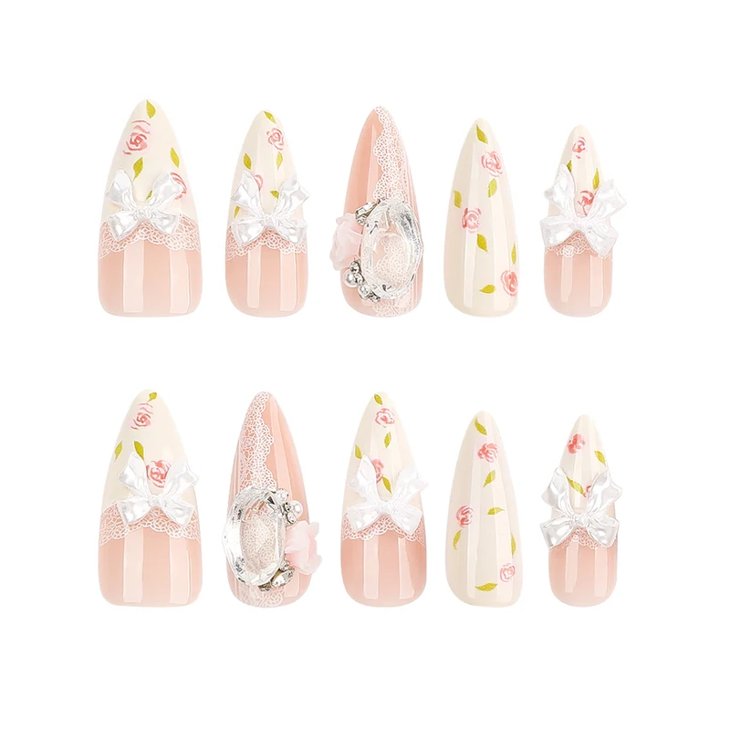 Kunstvolle Stiletto-Nägel mit floralen Akzenten und Glitzerakzenten Karnz