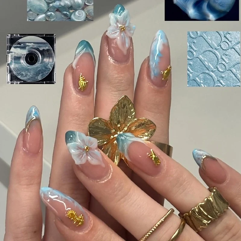 Kreatives Nagelset mit eleganten Goldverzierungen Karnz
