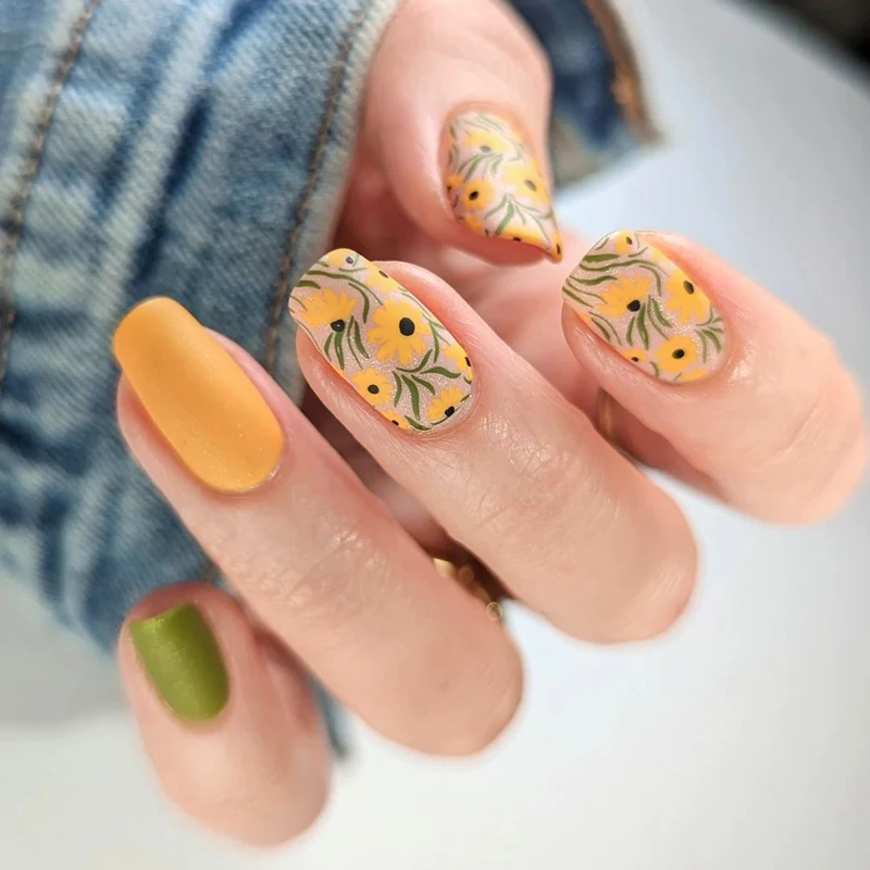 Kunstvolle Nagelverlängerungen mit floralen Designs und kreativen Farbakzenten Karnz
