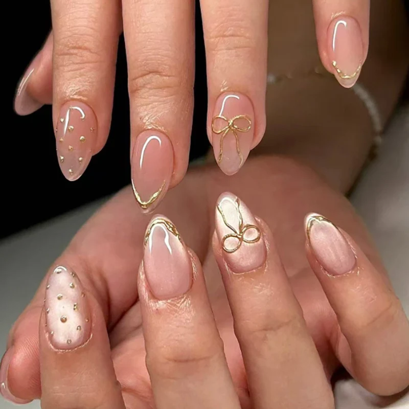 Kunstvolle Nagelverlängerungen mit eleganten goldenen Akzenten Karnz