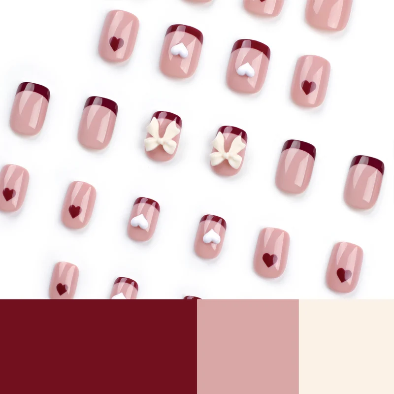 Kunstvolle Nagelkunst mit Herz- und Schleifenmotiven Karnz
