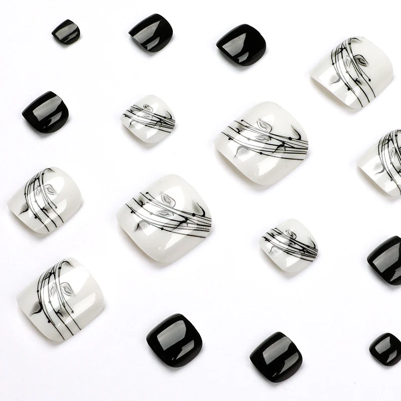Kunstvolle Fußnagelkunst im eleganten Schwarz-Weiß-Design Karnz