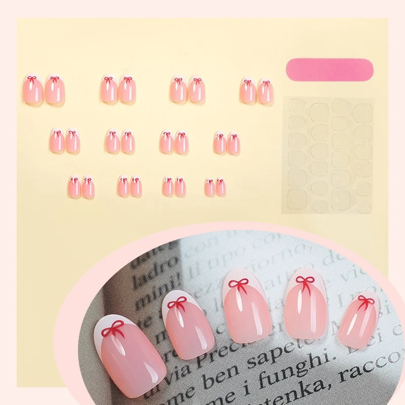 Kunstnagelset mit zarten Schleifenmotiven Karnz